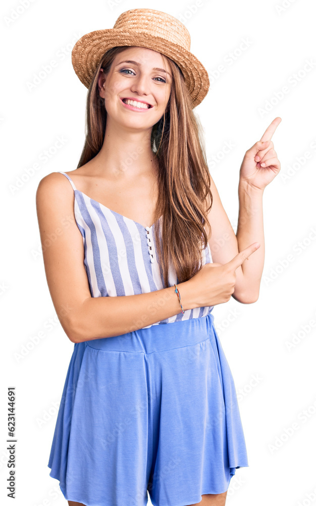 Young beautiful blonde woman wearing summer hat smiling and looking at the camera pointing with two hands and fingers to the side. Young beautiful blonde woman wearing summer hat smiling and looking at the camera pointing with two hands and fingers to the side.