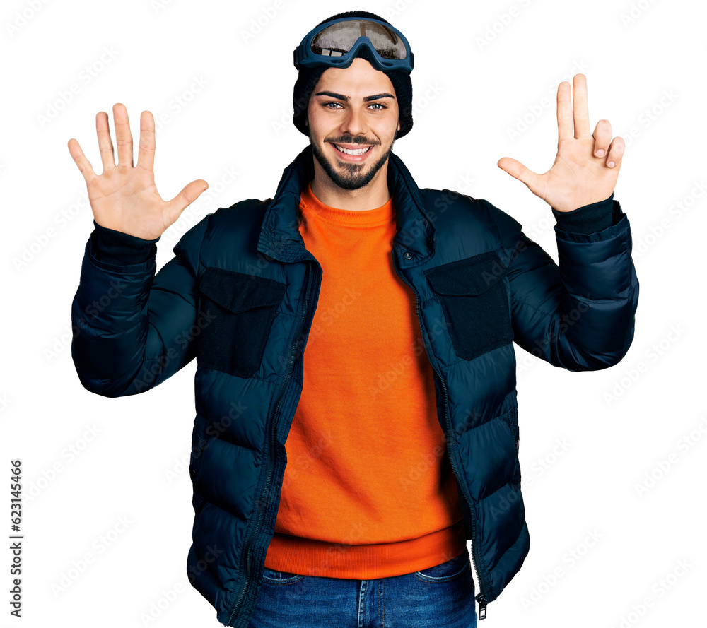 Young hispanic man with beard wearing snow wear and sky glasses showing and pointing up with fingers number eight while smiling confident and happy. Young hispanic man with beard wearing snow wear and sky glasses showing and pointing up with fingers number eight while smiling confident and happy.