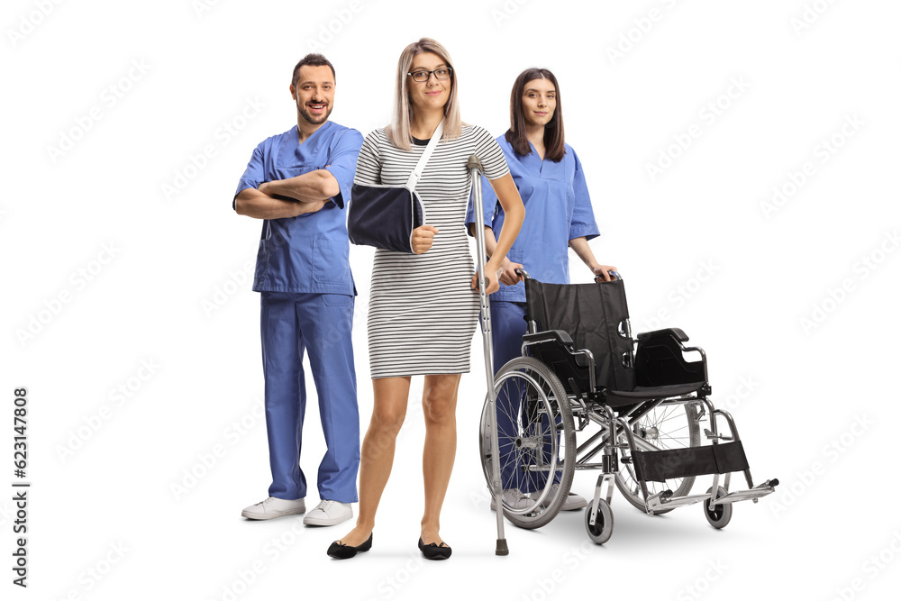 Woman with an injured arm and leg standing in front of health care workers Woman with an injured arm and leg standing in front of health care workers