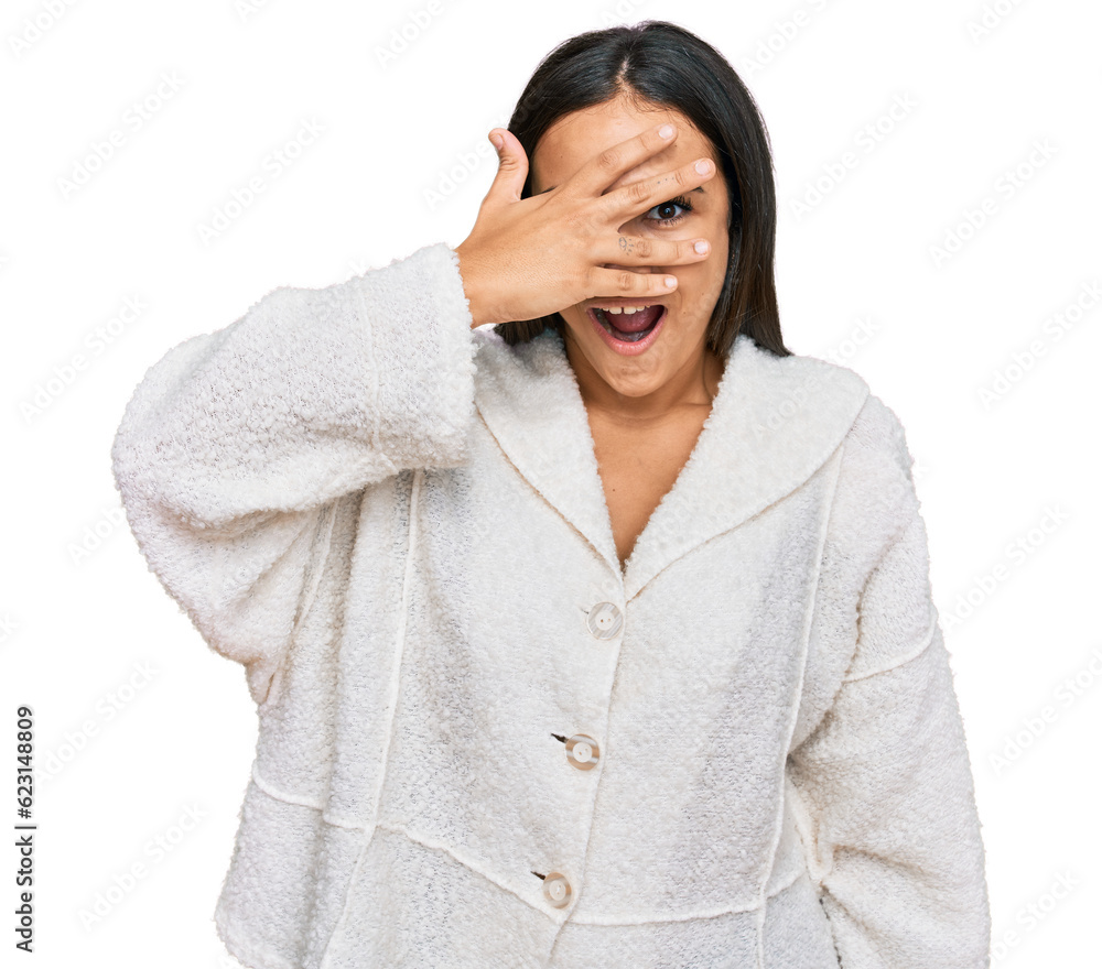 Young brunette woman wearing casual clothes peeking in shock covering face and eyes with hand, looking through fingers with embarrassed expression. Young brunette woman wearing casual clothes peeking in shock covering face and eyes with hand, looking through fingers with embarrassed expression.