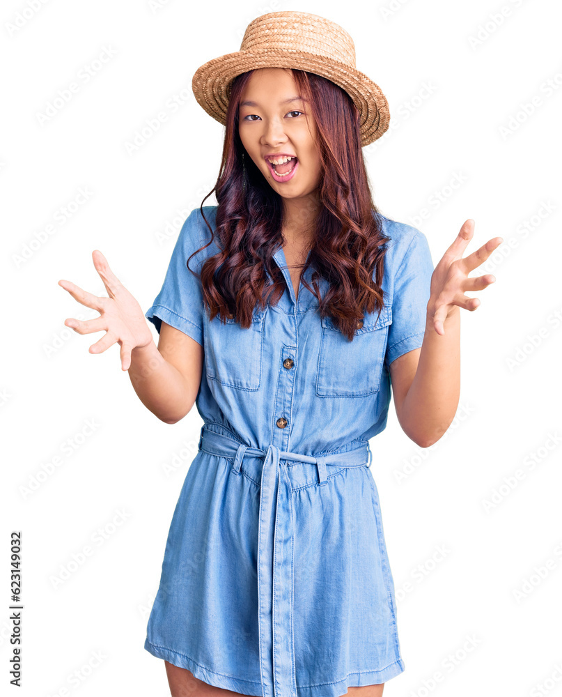 Young beautiful chinese girl wearing summer hat smiling cheerful offering hands giving assistance and acceptance. Young beautiful chinese girl wearing summer hat smiling cheerful offering hands giving assistance and acceptance.