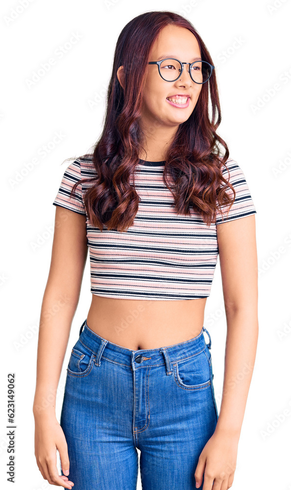 Fototapeta premium Young beautiful chinese girl wearing casual clothes looking away to side with smile on face, natural expression. laughing confident.