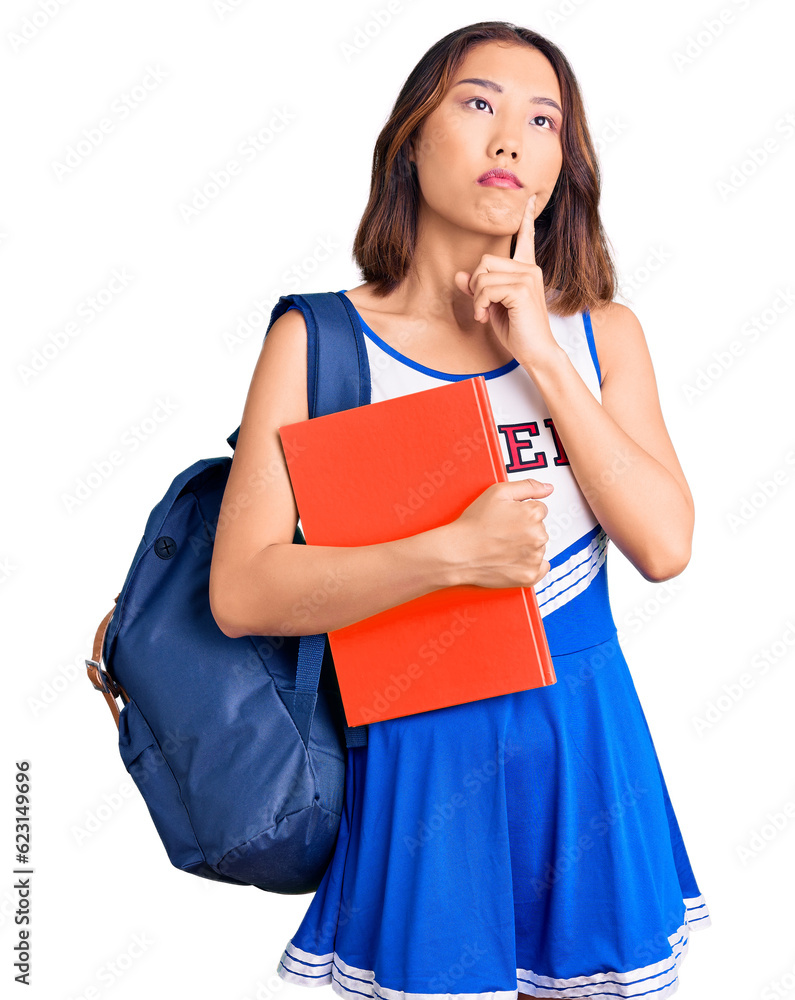 Young beautiful chinese girl wearing cheerleader uniform and student backpack holding binder serious face thinking about question with hand on chin, thoughtful about confusing idea Young beautiful chinese girl wearing cheerleader uniform and student backpack holding binder serious face thinking about question with hand on chin, thoughtful about confusing idea