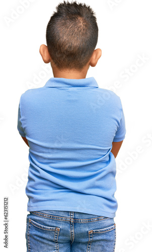 Obraz na plátne Little boy hispanic kid wearing casual clothes standing backwards looking away w