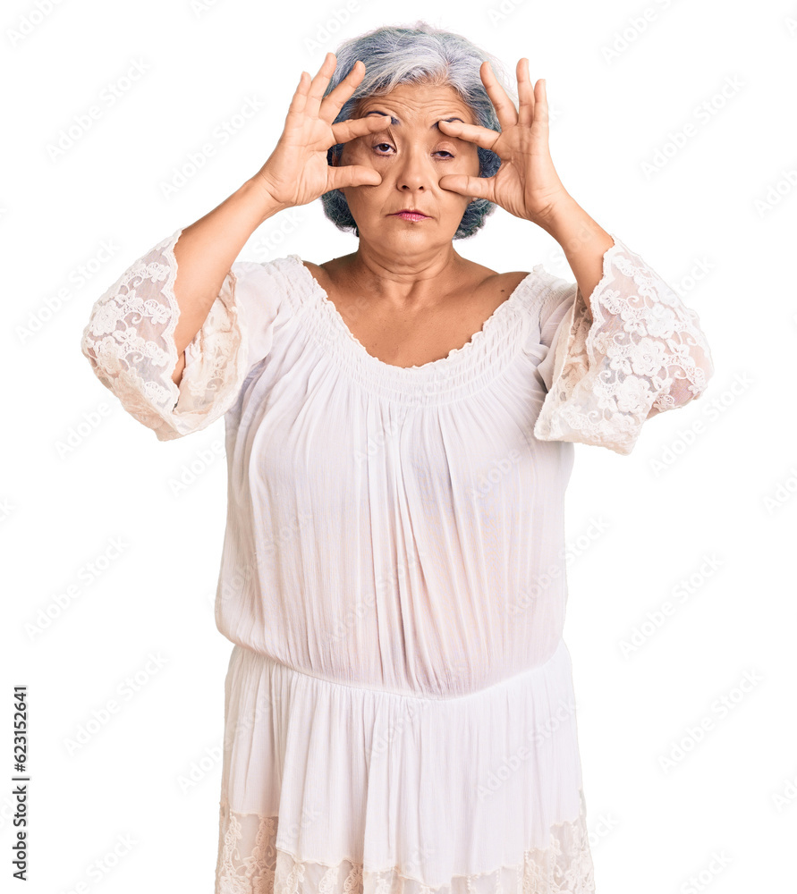 Senior woman with gray hair wearing bohemian style trying to open eyes with fingers, sleepy and tired for morning fatigue Senior woman with gray hair wearing bohemian style trying to open eyes with fingers, sleepy and tired for morning fatigue