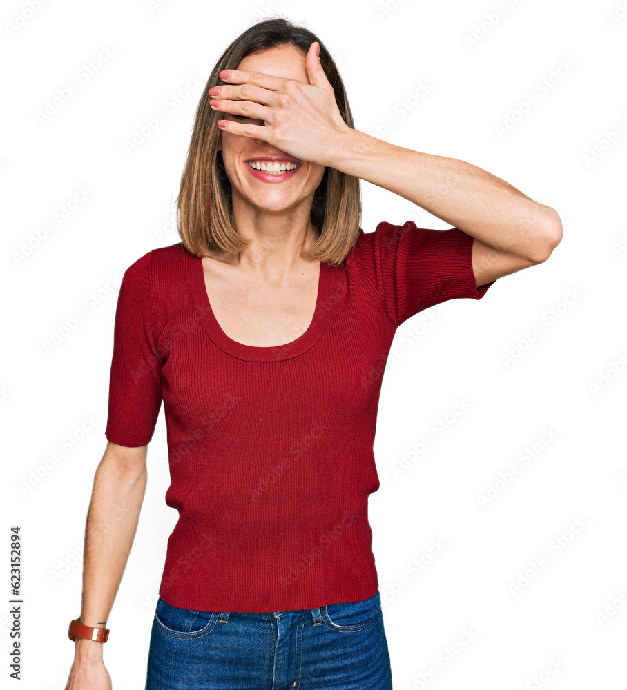 Young blonde girl wearing casual clothes smiling and laughing with hand on face covering eyes for surprise. blind concept. Young blonde girl wearing casual clothes smiling and laughing with hand on face covering eyes for surprise. blind concept.