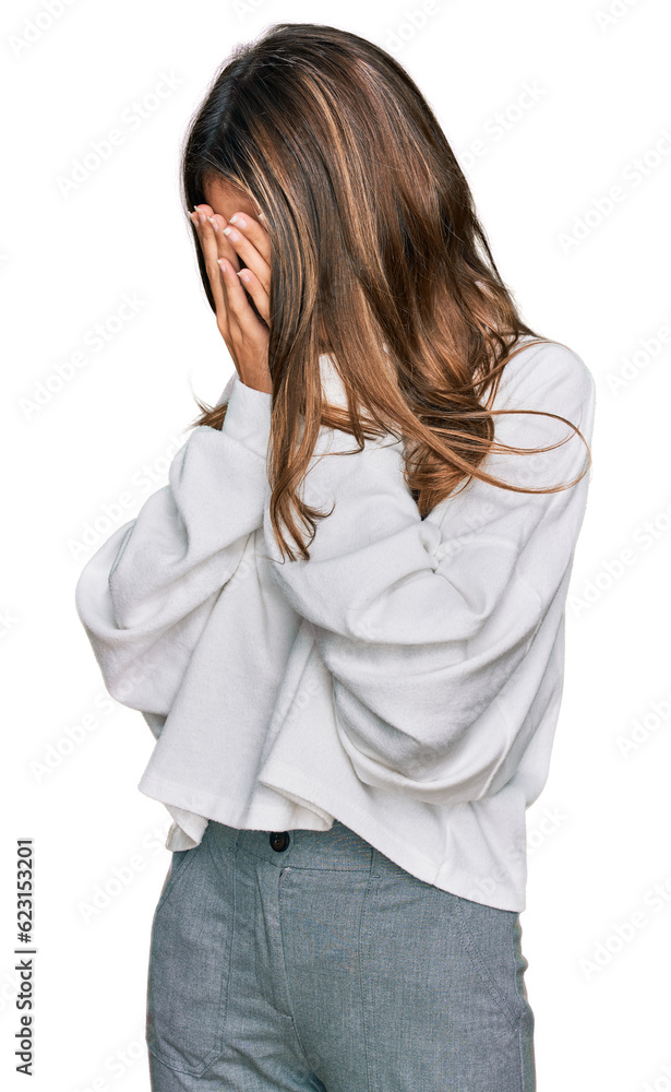 Young brunette woman wearing casual turtleneck sweater with sad expression covering face with hands while crying. depression concept. Young brunette woman wearing casual turtleneck sweater with sad expression covering face with hands while crying. depression concept.