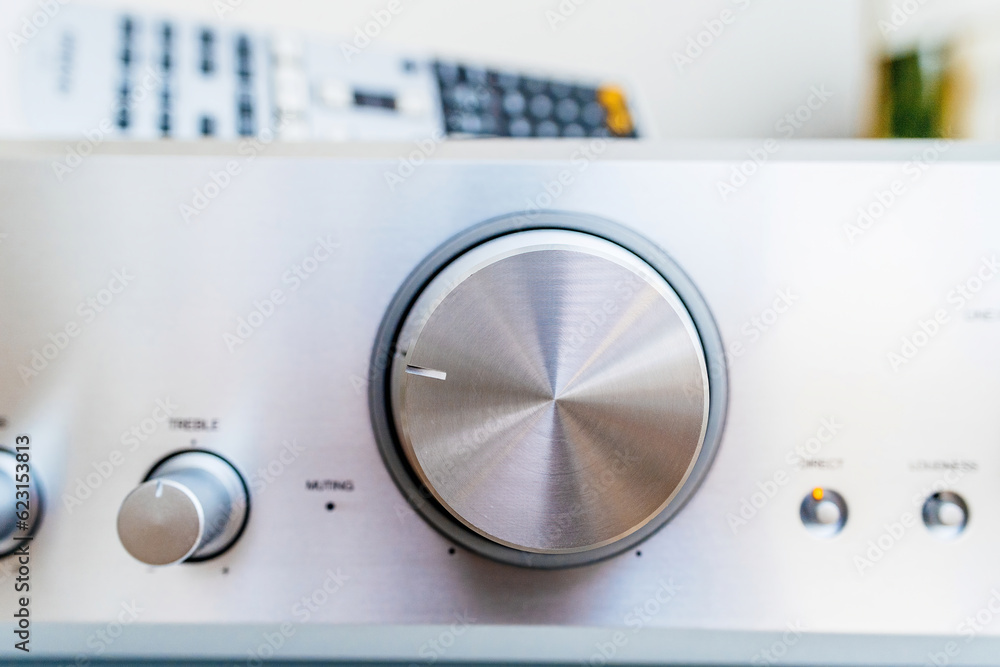 Enhance audio experience with aluminum hi-fi device, close-up of volume knob for precise control and creative musical expression. Enhance audio experience with aluminum hi-fi device, close-up of volume knob for precise control and creative musical expression.