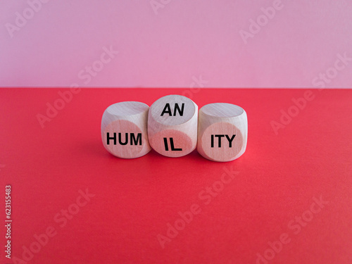 Humility vs humanity symbol. Turned cubes and changed the word  humility  to  humanity . Beautiful red table  pink background  copy space. Business and humility vs humanity concept