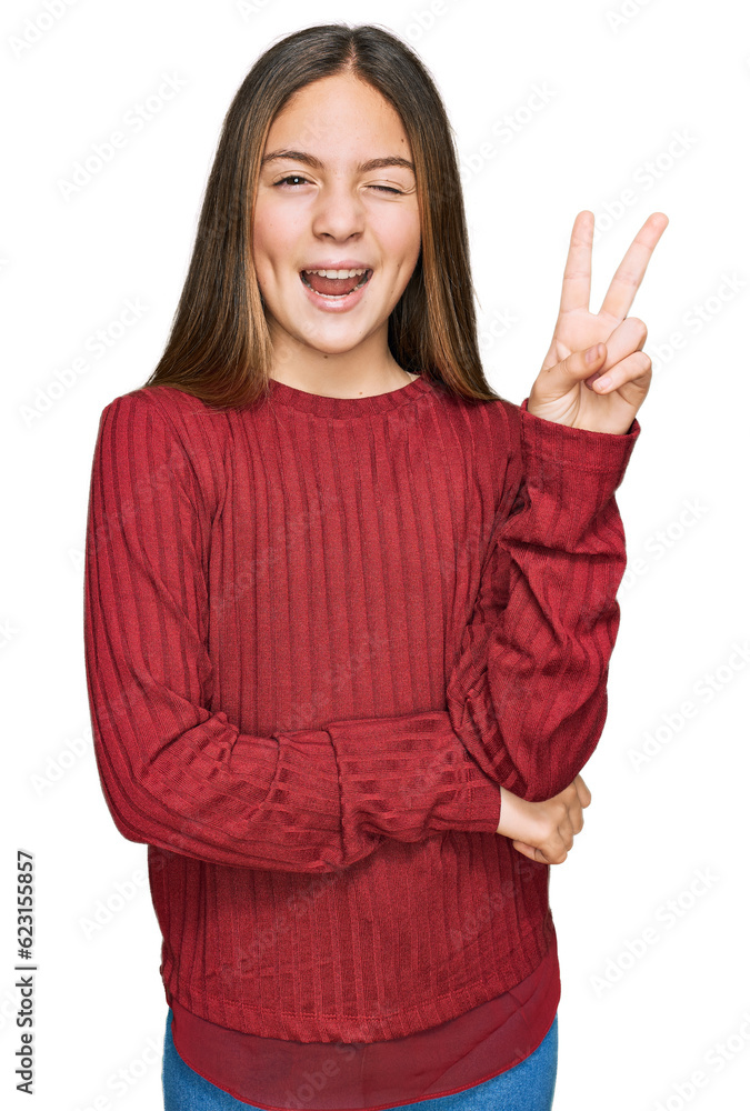 Beautiful brunette little girl wearing casual sweater smiling with happy face winking at the camera doing victory sign. number two. Beautiful brunette little girl wearing casual sweater smiling with happy face winking at the camera doing victory sign. number two.