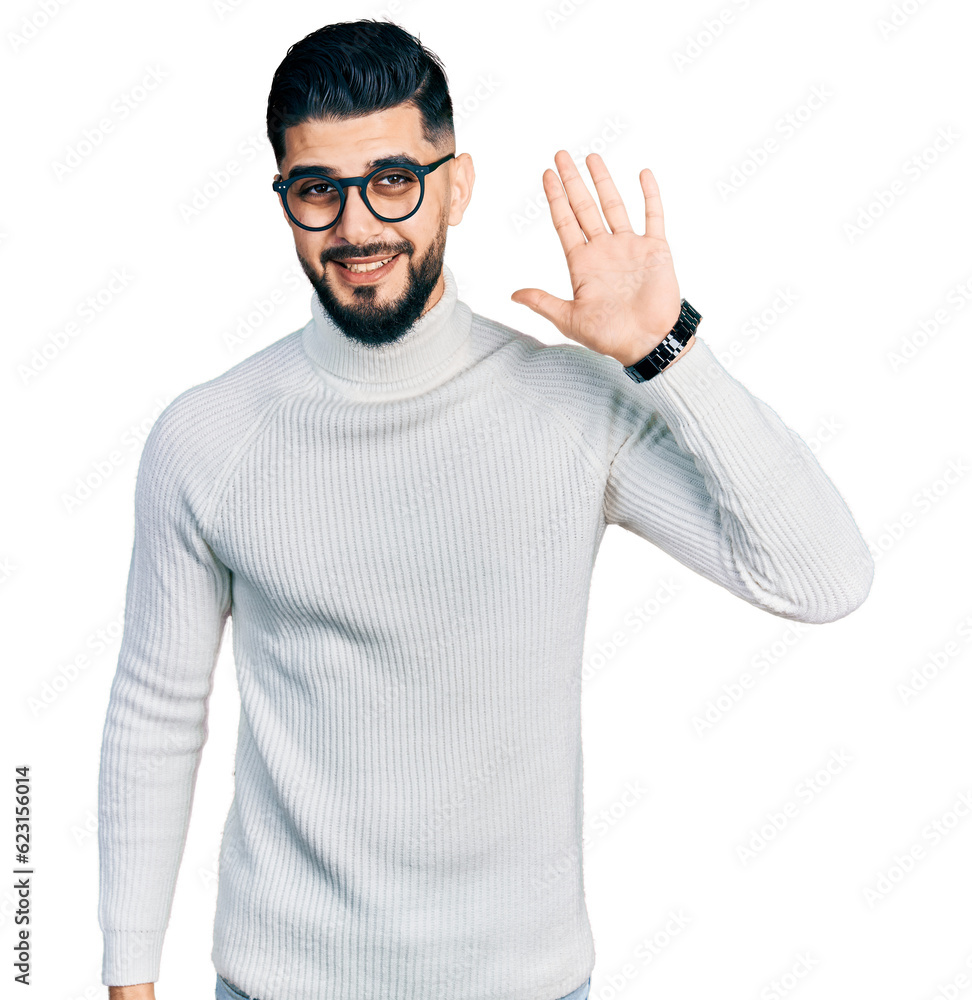 Young arab man with beard wearing elegant turtleneck sweater and glasses waiving saying hello happy and smiling, friendly welcome gesture Young arab man with beard wearing elegant turtleneck sweater and glasses waiving saying hello happy and smiling, friendly welcome gesture