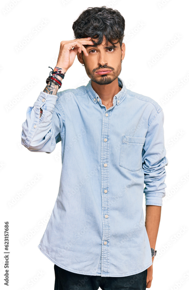 Young hispanic man wearing casual clothes worried and stressed about a problem with hand on forehead, nervous and anxious for crisis Young hispanic man wearing casual clothes worried and stressed about a problem with hand on forehead, nervous and anxious for crisis
