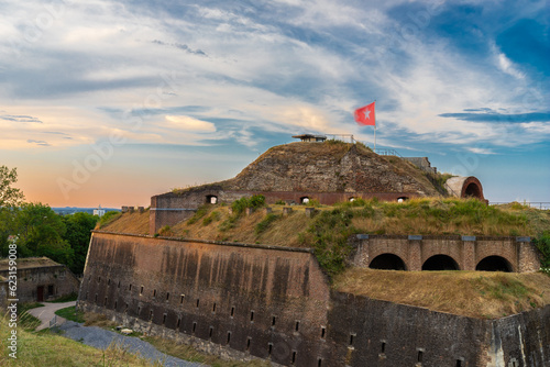 The medieval fortress in Maastricht strategically located on the slopes of the Sint Pietersberg hill during a spectacular sunset with a dramatic sky and rays of sun. photo