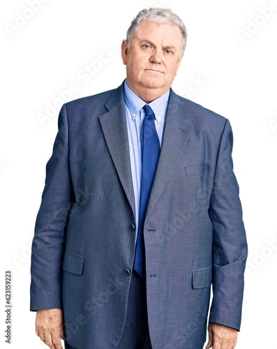 Senior grey-haired man wearing business jacket looking sleepy and tired, exhausted for fatigue and hangover, lazy eyes in the morning.