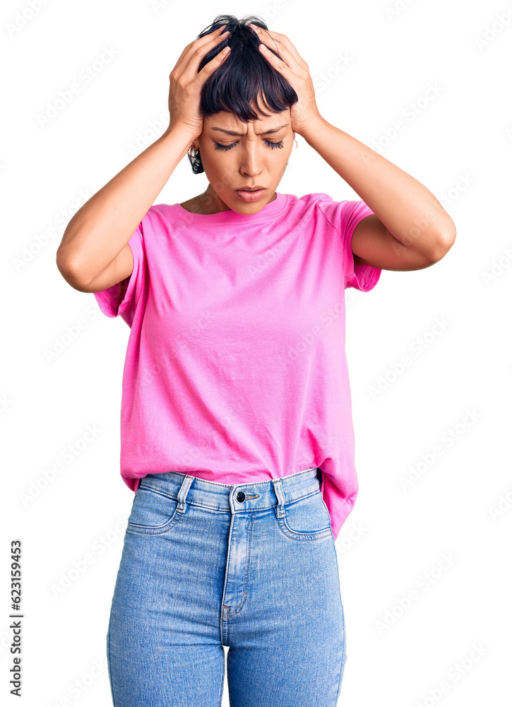 Young brunette woman with short hair wearing casual clothes suffering from headache desperate and stressed because pain and migraine. hands on head. Young brunette woman with short hair wearing casual clothes suffering from headache desperate and stressed because pain and migraine. hands on head.