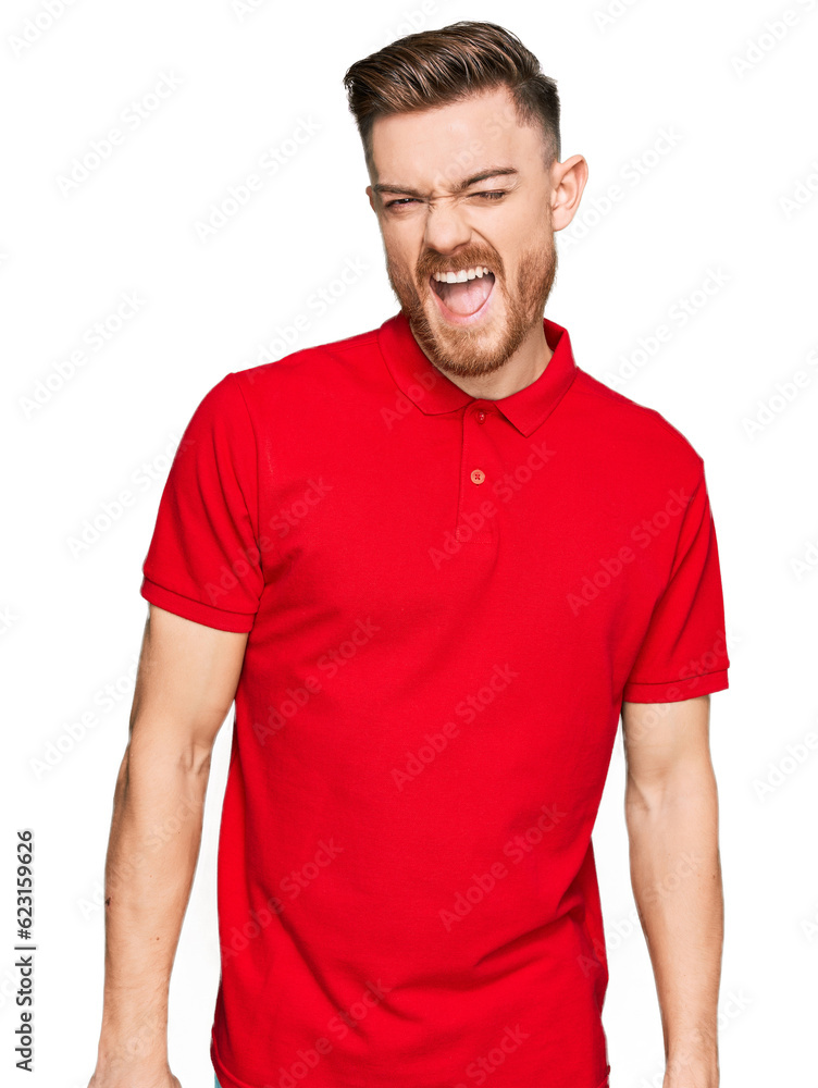 Young redhead man wearing casual clothes winking looking at the camera with sexy expression, cheerful and happy face.