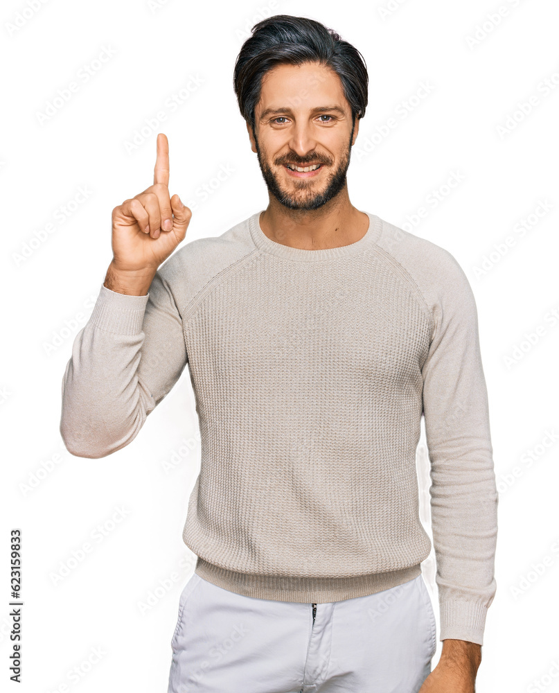 Young hispanic man wearing casual clothes pointing finger up with successful idea. exited and happy. number one. Young hispanic man wearing casual clothes pointing finger up with successful idea. exited and happy. number one.