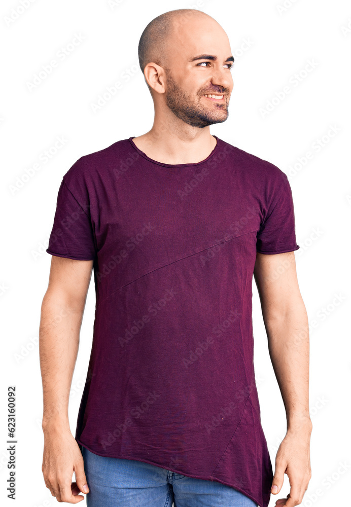 Young handsome man wearing casual t shirt looking away to side with smile on face, natural expression. laughing confident. Young handsome man wearing casual t shirt looking away to side with smile on face, natural expression. laughing confident.