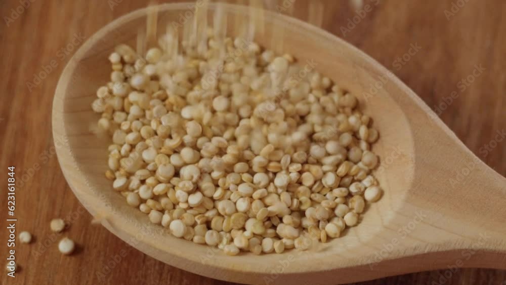 White quinoa uncooked seeds texture close up. Selective focus. Slow motion White quinoa uncooked seeds texture close up. Selective focus. Slow motion
