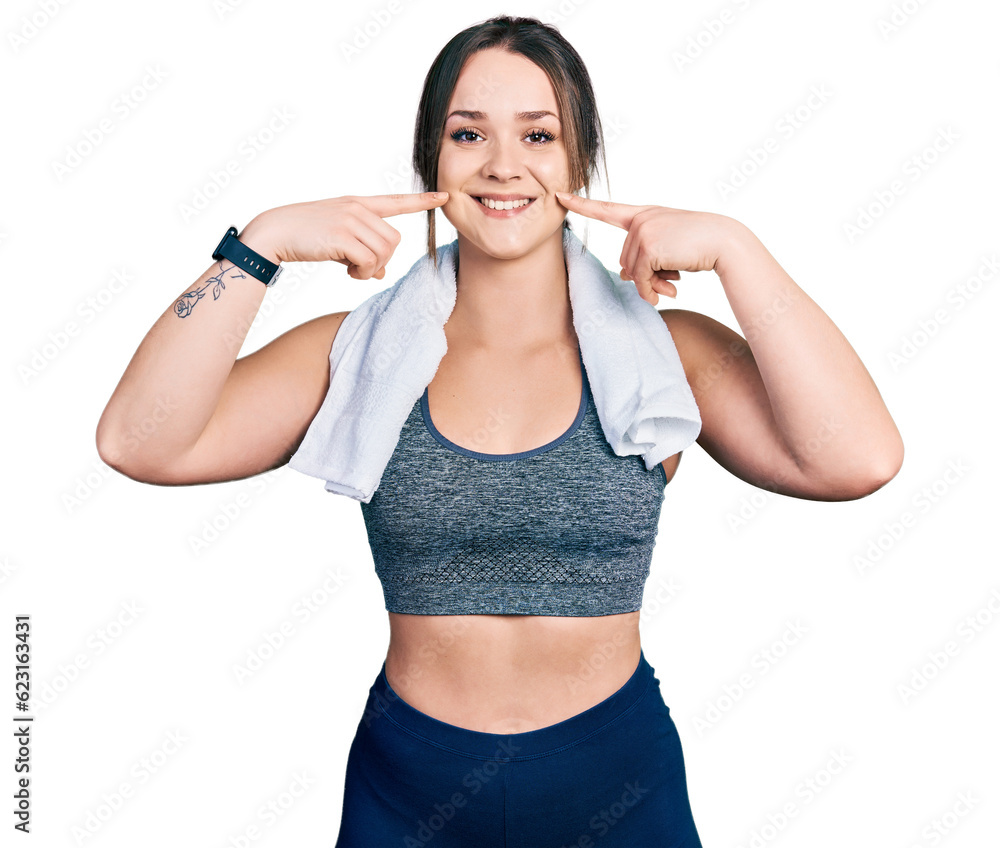 Young hispanic girl wearing sportswear and towel smiling cheerful showing and pointing with fingers teeth and mouth. dental health concept. Young hispanic girl wearing sportswear and towel smiling cheerful showing and pointing with fingers teeth and mouth. dental health concept.
