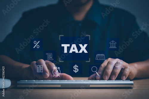 concept Financial or income to calculate taxes online. Man typing with computer keyboard showing income or expenditure to fill out personal income tax payment form for government agency photo