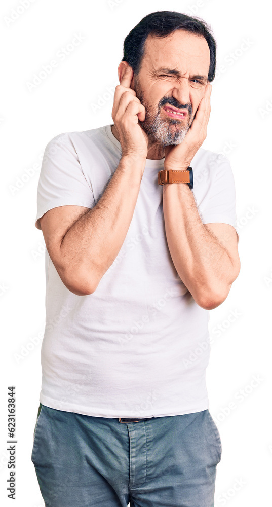 Middle age handsome man wearing casual t-shirt covering ears with fingers with annoyed expression for the noise of loud music. deaf concept. Middle age handsome man wearing casual t-shirt covering ears with fingers with annoyed expression for the noise of loud music. deaf concept.