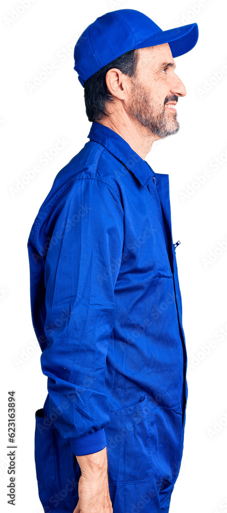 Middle age handsome man wearing mechanic uniform looking to side, relax profile pose with natural face and confident smile. Middle age handsome man wearing mechanic uniform looking to side, relax profile pose with natural face and confident smile.