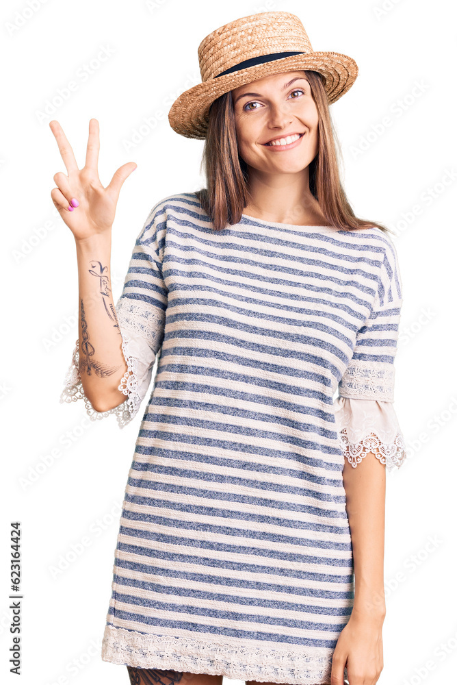 Beautiful caucasian woman wearing summer hat showing and pointing up with fingers number three while smiling confident and happy. Beautiful caucasian woman wearing summer hat showing and pointing up with fingers number three while smiling confident and happy.