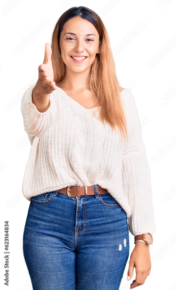 Beautiful young woman wearing casual clothes smiling friendly offering handshake as greeting and welcoming. successful business. Beautiful young woman wearing casual clothes smiling friendly offering handshake as greeting and welcoming. successful business.