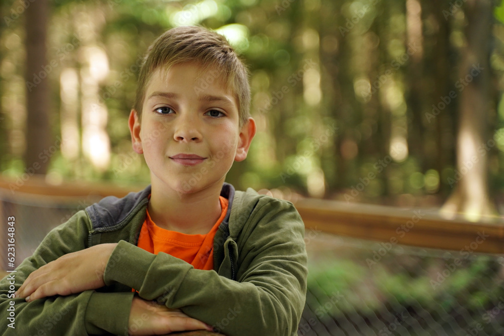 Close-up portrait of a cute boy on a green blurred background. Close-up portrait of a cute boy on a green blurred background.