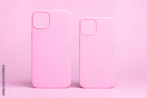 set of two pink cases for iPhone 15 and 14 Plus or iPhone 13 and 13 mini back view isolated on pink background, monochrome colours phone case mock up