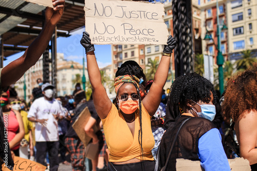 Black woman with no justice no peace poster during demonstration photo