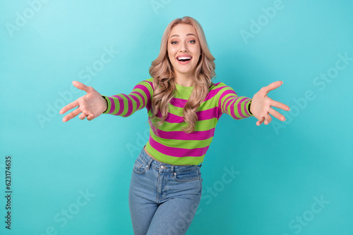 Photo of pretty friendly woman dressed striped sweater open arms ready hug you isolated turquoise color background