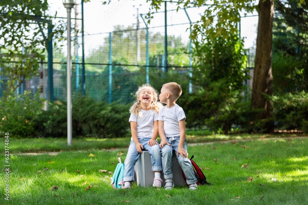 Two smile happy schoolchildren in park about school. Two smile happy schoolchildren in park about school.