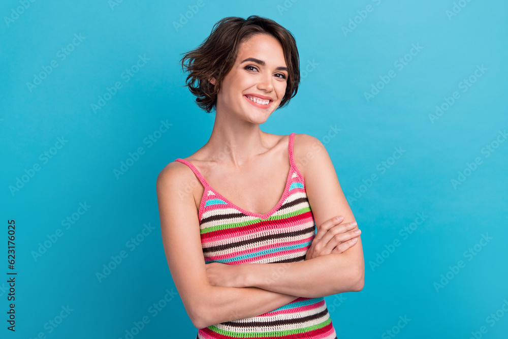 Portrait cadre of young gorgeous nice pretty woman crossed arms wear striped knitted stylish singlet isolated on blue color background Portrait cadre of young gorgeous nice pretty woman crossed arms wear striped knitted stylish singlet isolated on blue color background