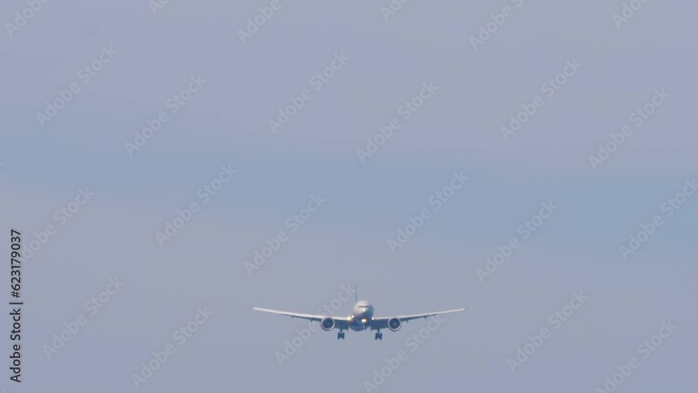 Passenger jet aircraft approaching landing, view from below. Airliner in the sky. Flight arrival. Air transport concept Passenger jet aircraft approaching landing, view from below. Airliner in the sky. Flight arrival. Air transport concept