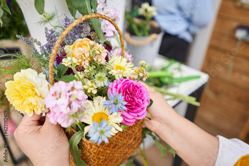 Master class on making bouquets. Spring bouquet in wicker basket. Learning flower arranging, making beautiful bouquets with your own hands