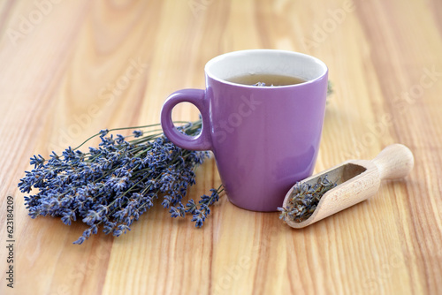 Cup of tea and lavender flowers on a wooden table