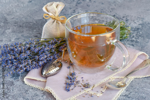 Fresh delicious tea with lavender and lavender flowers on gray stone table