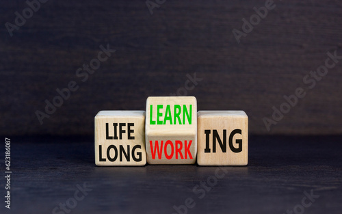 Lifelong learning working symbol. Concept word Lifelong learning working on block on a beautiful grey table grey background. Business educational lifelong learning working concept. Copy space