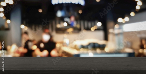 empty black marble table at foreground with blurred view of cafe and baristas staff at background used as product displayed. interior background for advertising products such as coffee, beverage.