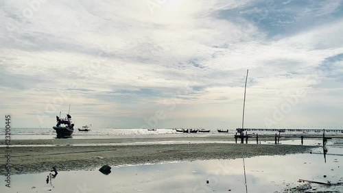 fishing boats during sunset sky at beach landscape, fishing boats during a sunrise or sunset, shimmering of the sun on the clouds,the sky and clouds have the power to inspire feelings of awe or wonder photo