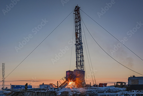 Well repair at a gas field in the Arctic. Winter polar evening. Frost. Snow. Mobile rig for well repair with a derrick and other equipment