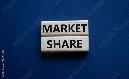 Market Share symbol. Wooden blocks with words Market Sharer. Beautiful deep blue background. Business and Market Share concept. Copy space.