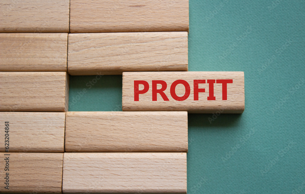 Profit symbol. Concept word Profit on wooden blocks. Beautiful grey green background. Business and Profit concept. Copy space. Profit symbol. Concept word Profit on wooden blocks. Beautiful grey green background. Business and Profit concept. Copy space.