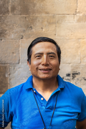 Street portrait of a smiling Peruvian man in the city of Barcelona (Spain).