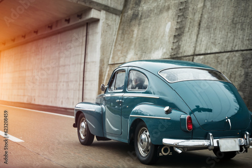 Vintage European Beauty in Motion. Blue Oldtimer Coupe Speeding Through the Streets.