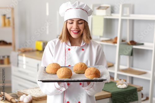Female baker with tray of t...