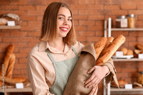 Female baker with fresh bag...