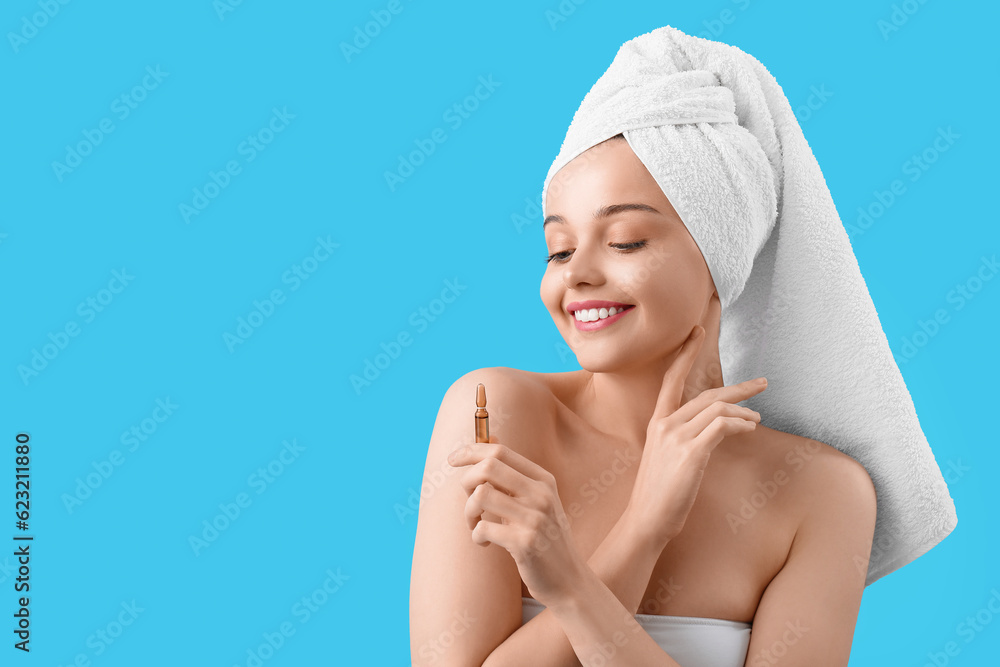Beautiful young woman with ampule on blue background. Skin care concept Beautiful young woman with ampule on blue background. Skin care concept